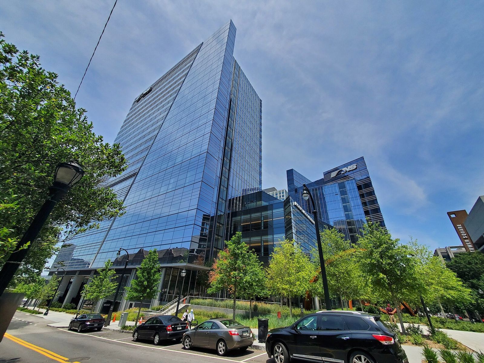 Norfolk Southern: Glass tower behind trees and parked cars