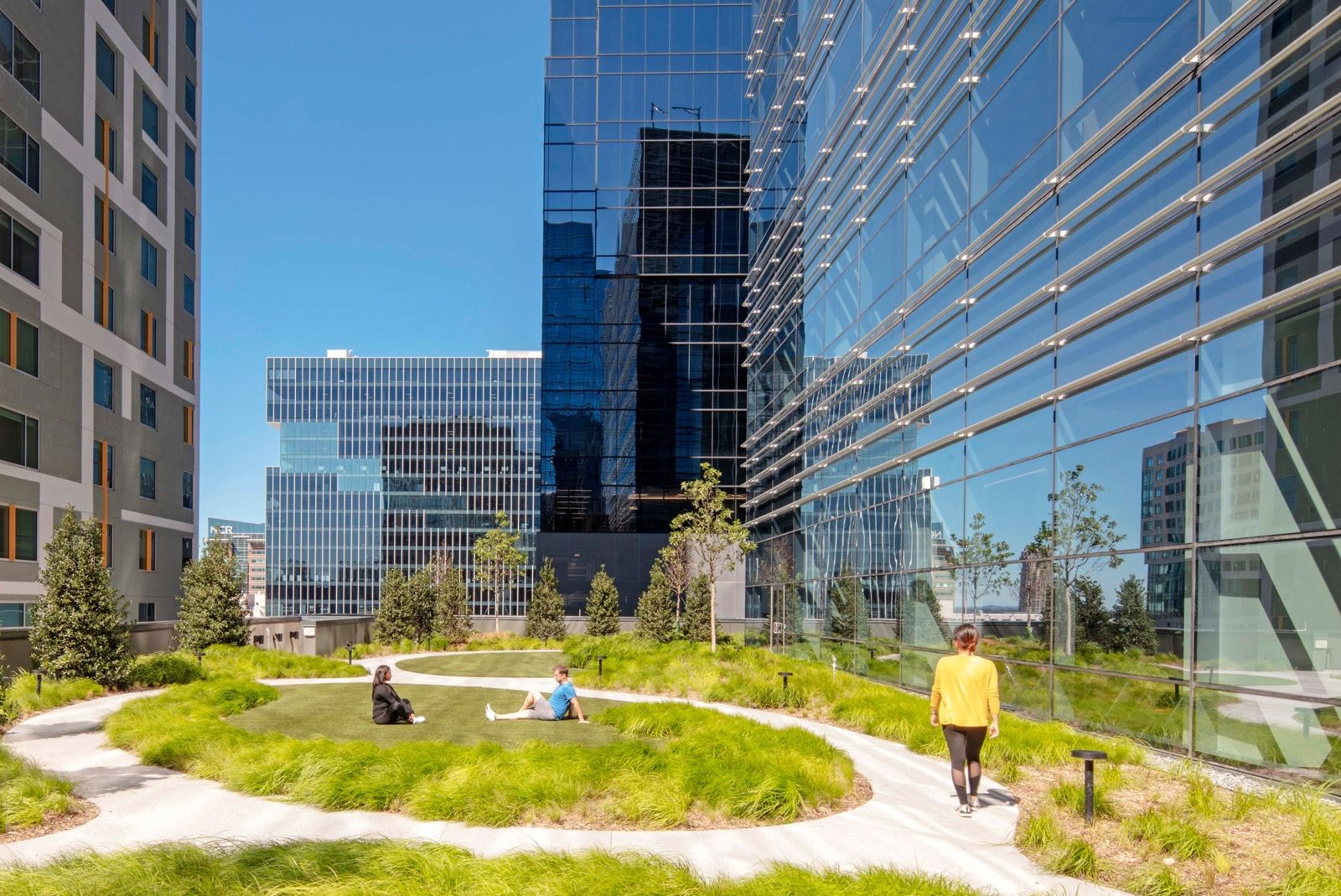 Norfolk Southern: Green lawn and paths on a terrace between glass towers