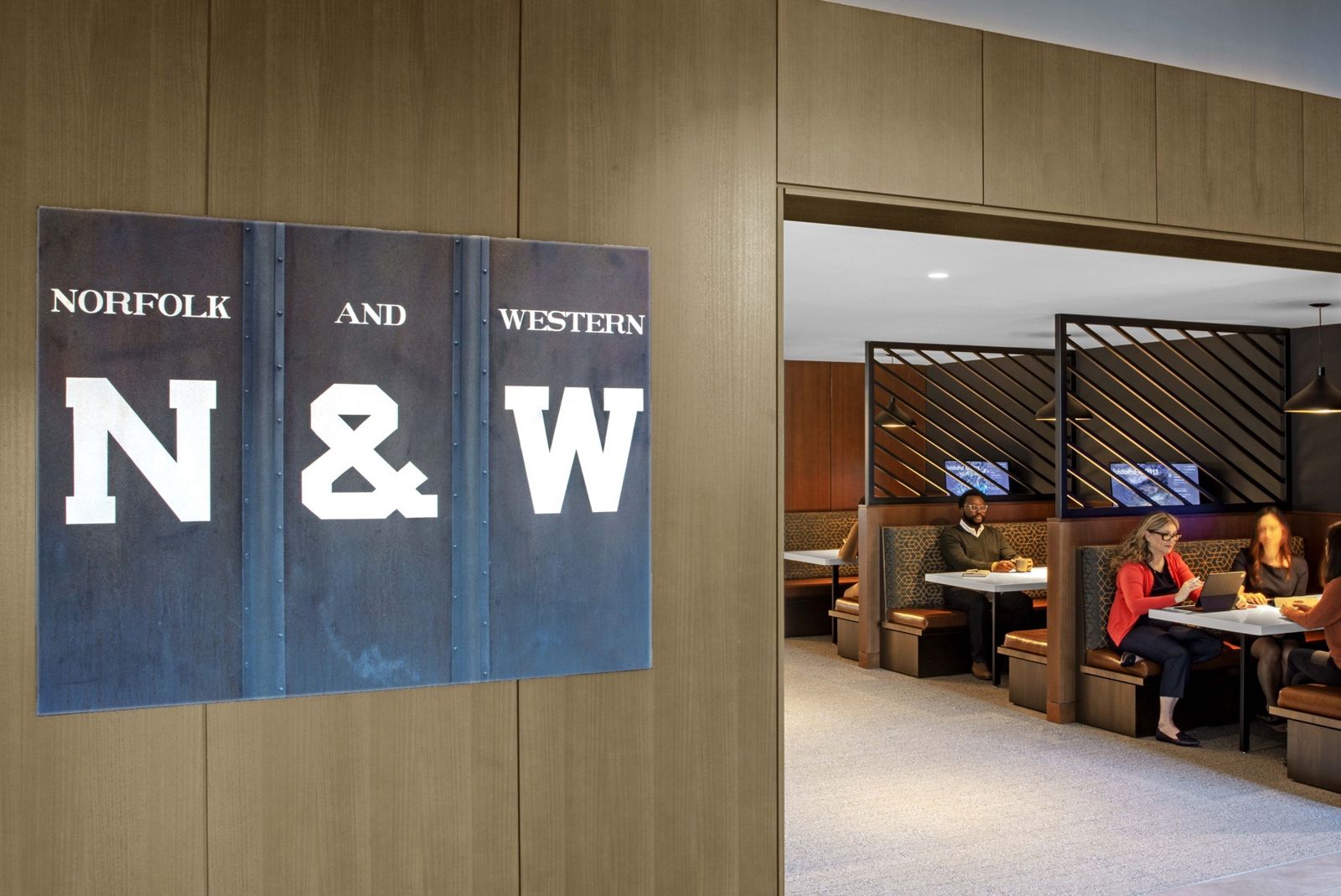 Norfolk Southern: Large N and W letters on a wall beside booths