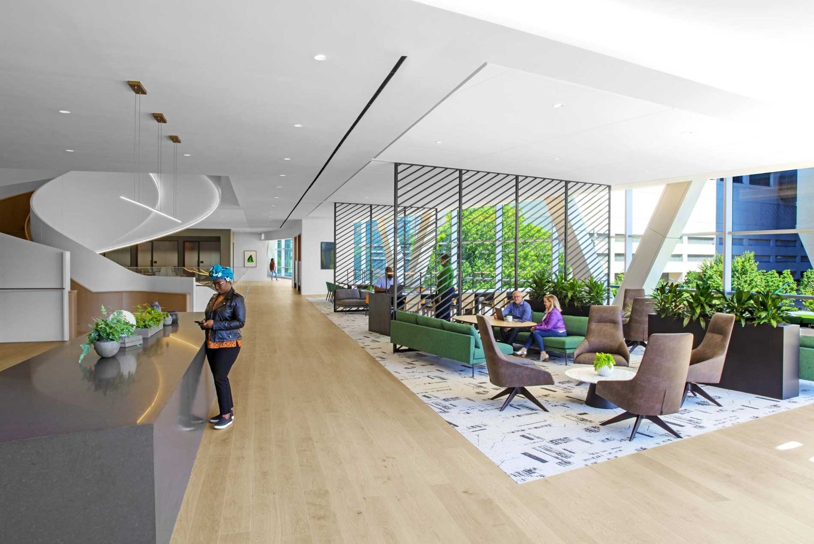 Norfolk Southern: Lounge chairs and plants in a bright lobby with a curving stair
