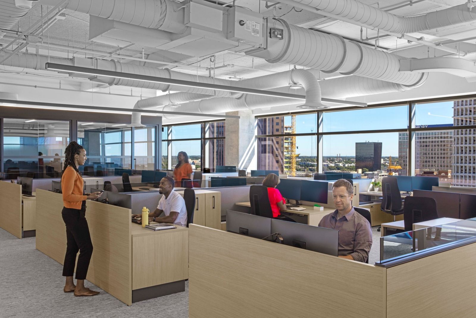 Norfolk Southern: Rows of desks by windows with people at work