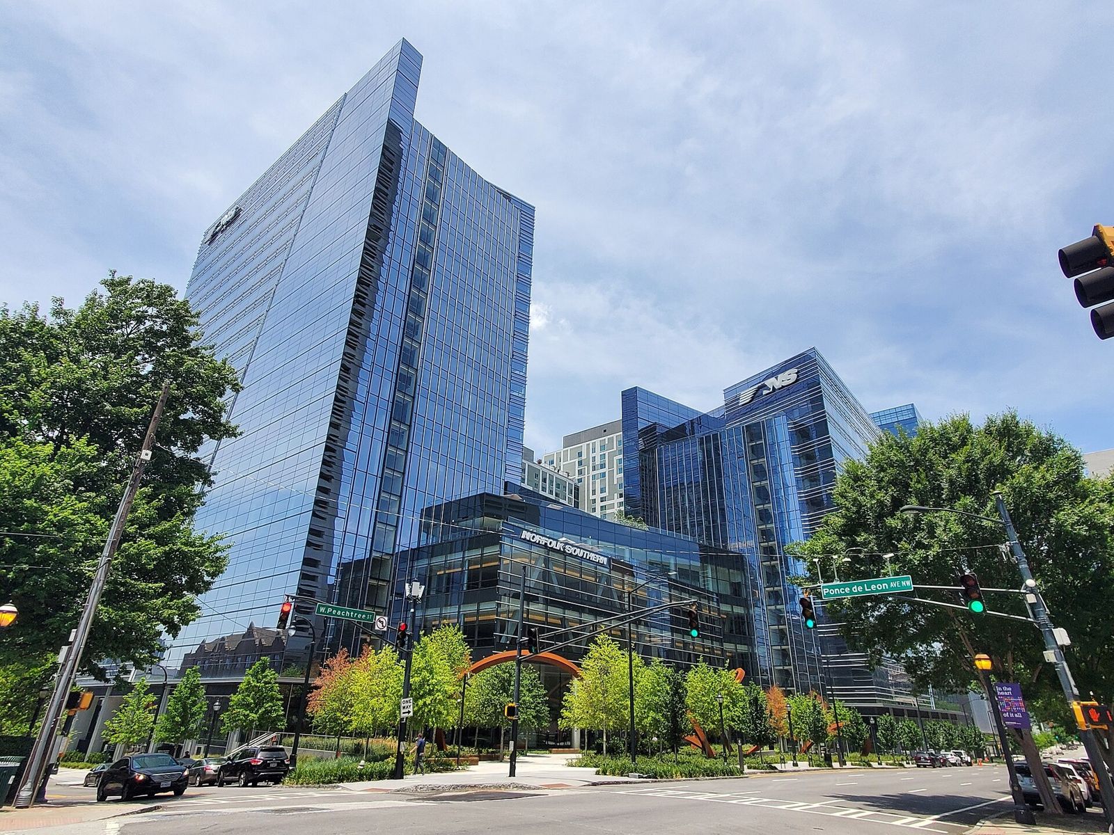 Norfolk Southern: Two glass towers above street trees at an intersection