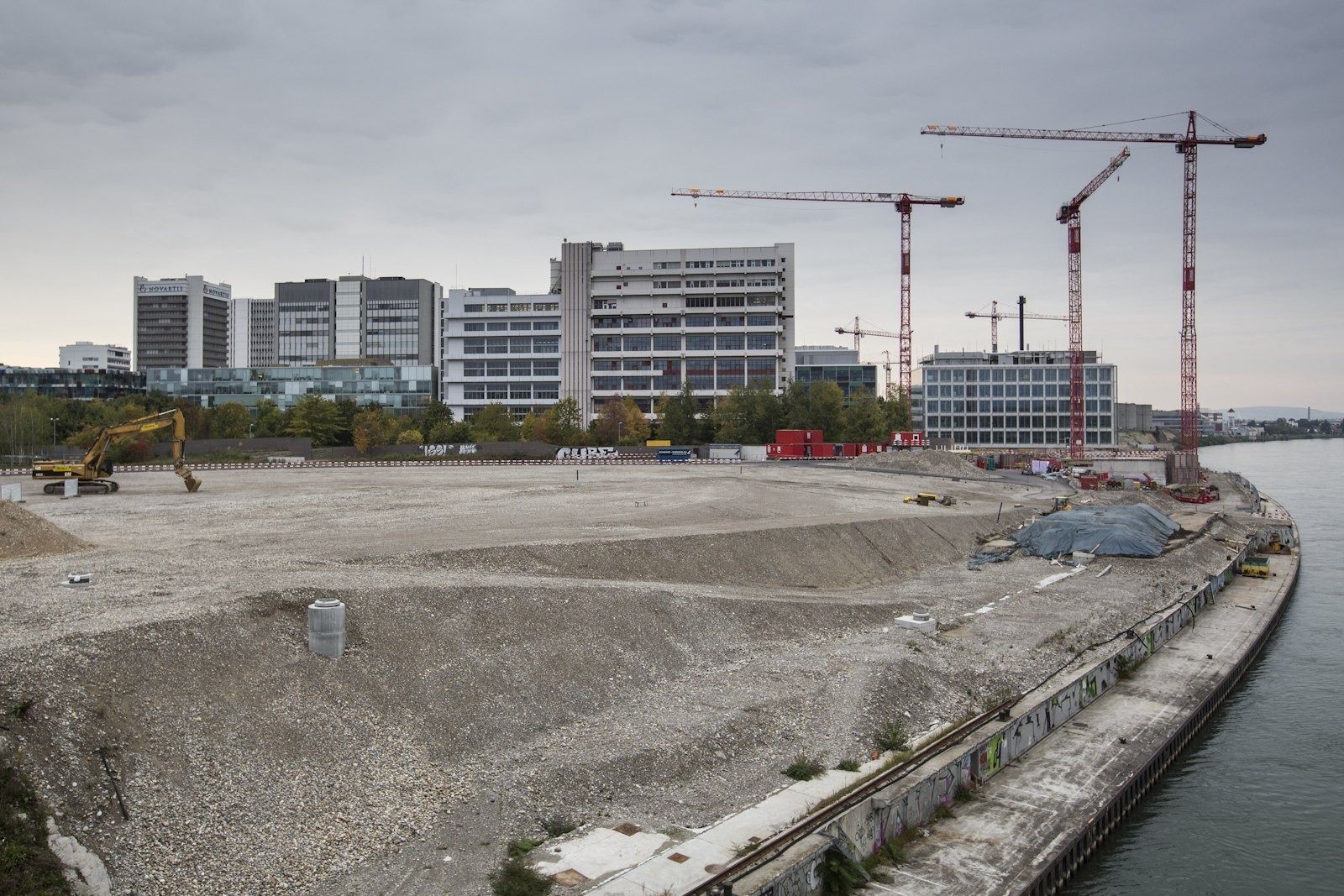 Building site with cranes beside campus buildings