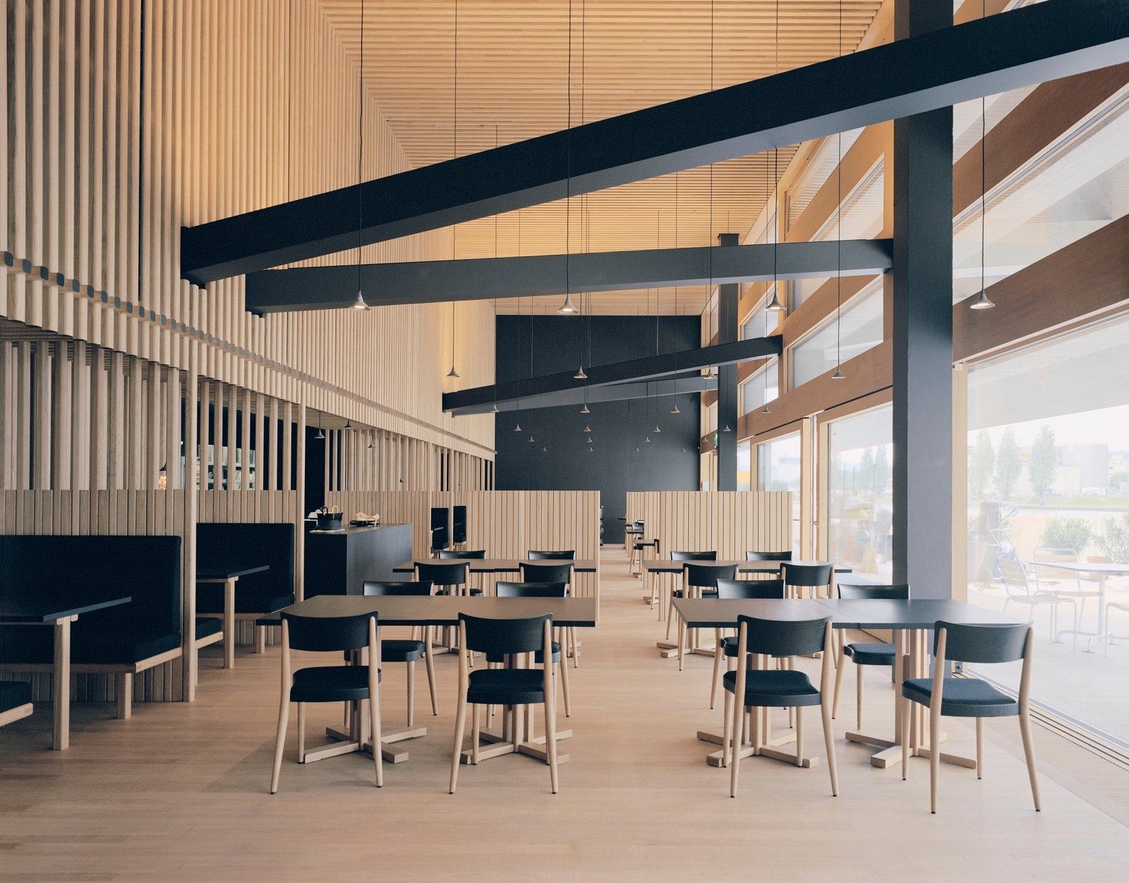 Novartis: Dining area with wooden ceiling slats and dark chairs
