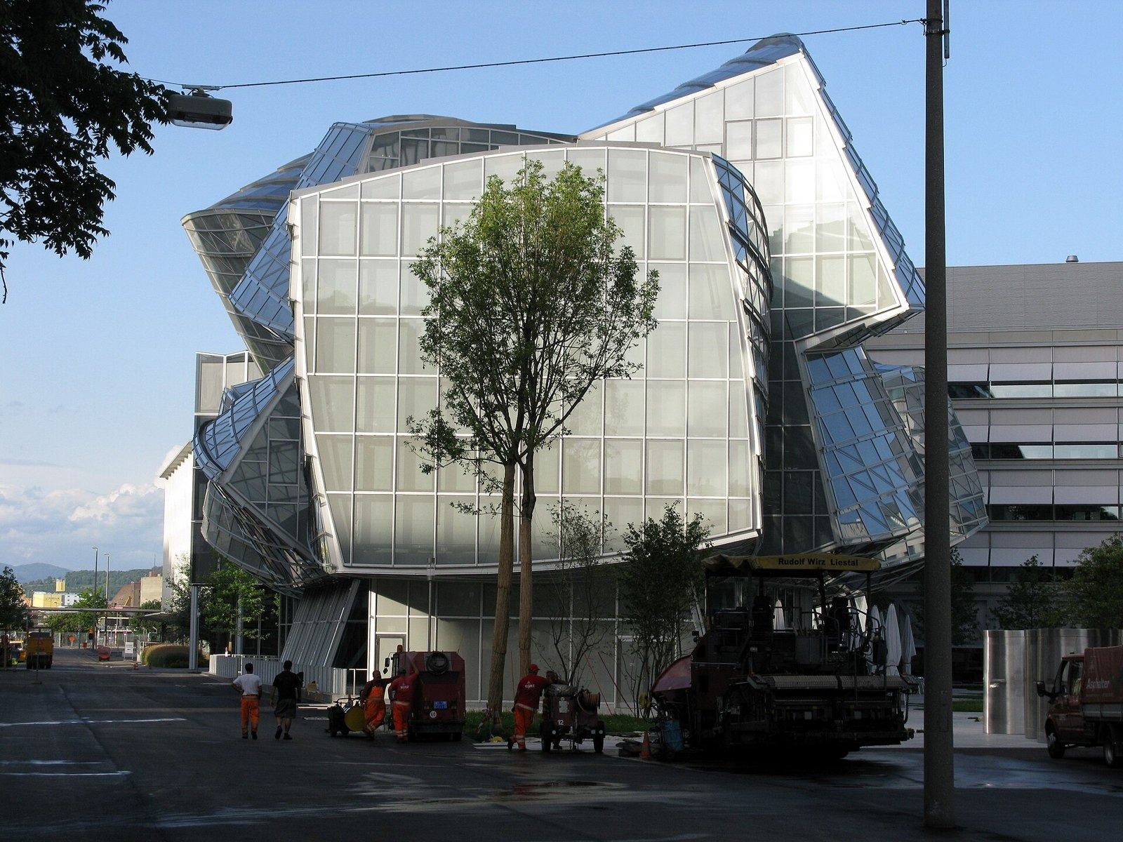 Novartis: Gehry's glass building with a tree in front