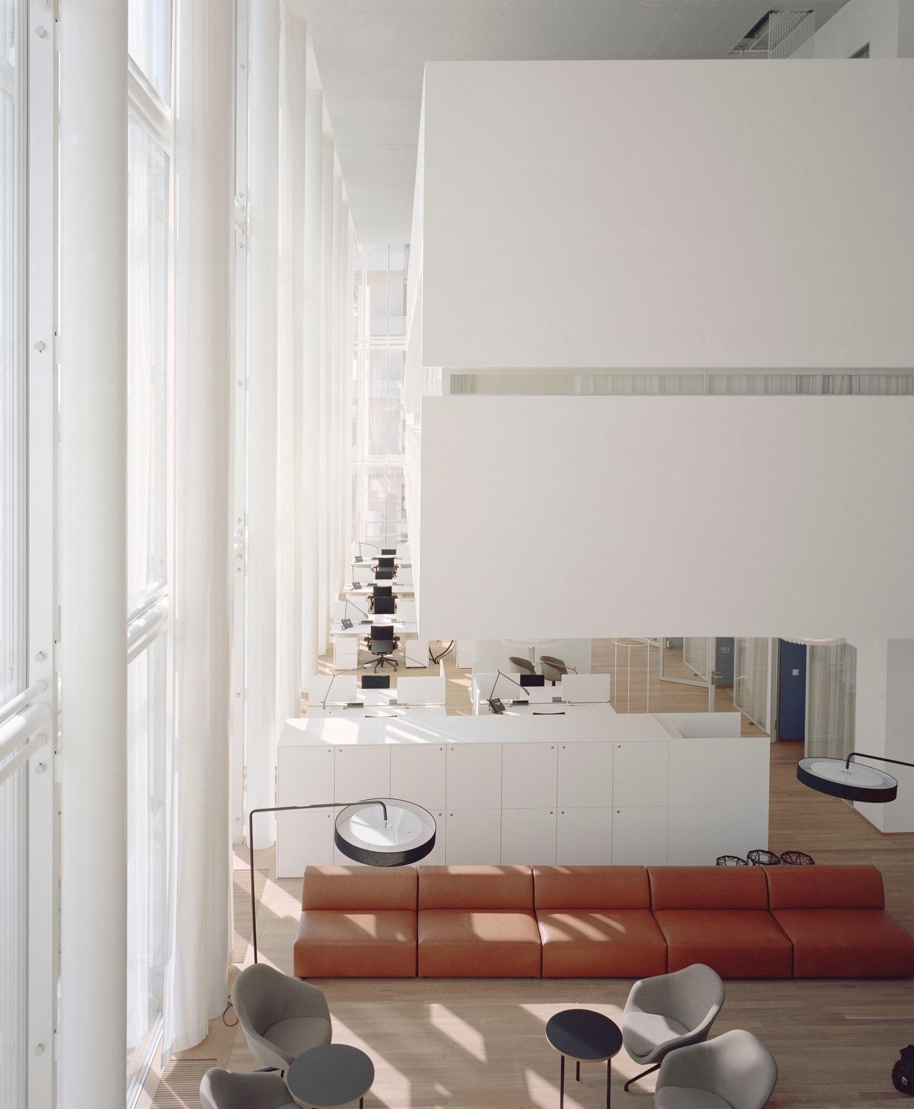 Novartis: Lounge with a red sofa under a high ceiling