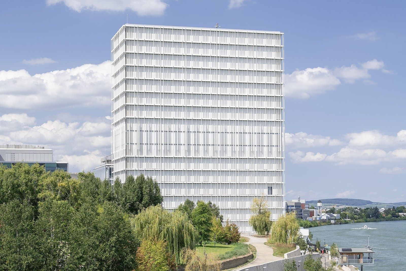 Novartis: White office building above the riverside