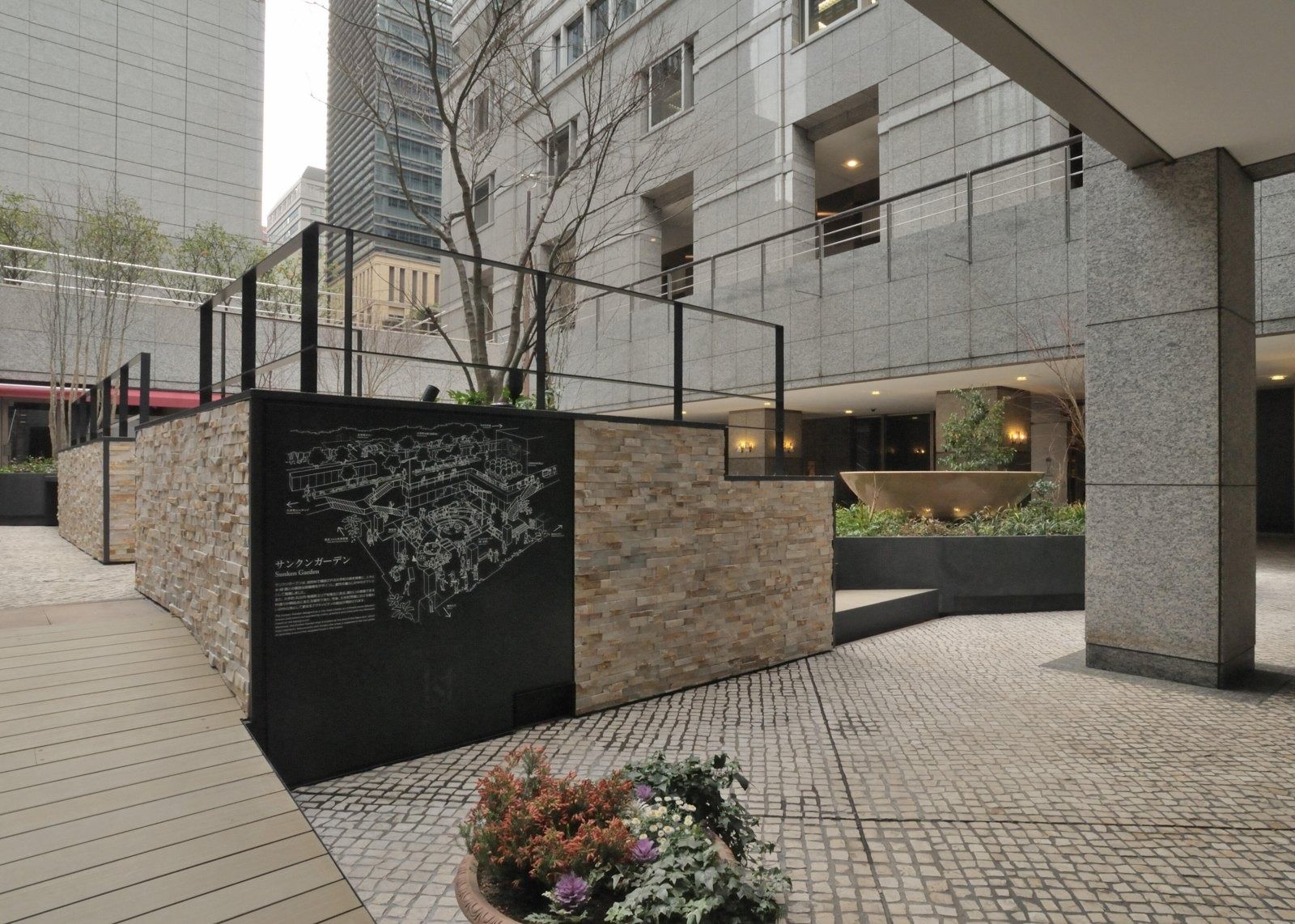 NTT: Stone walls and planting along a walkway
