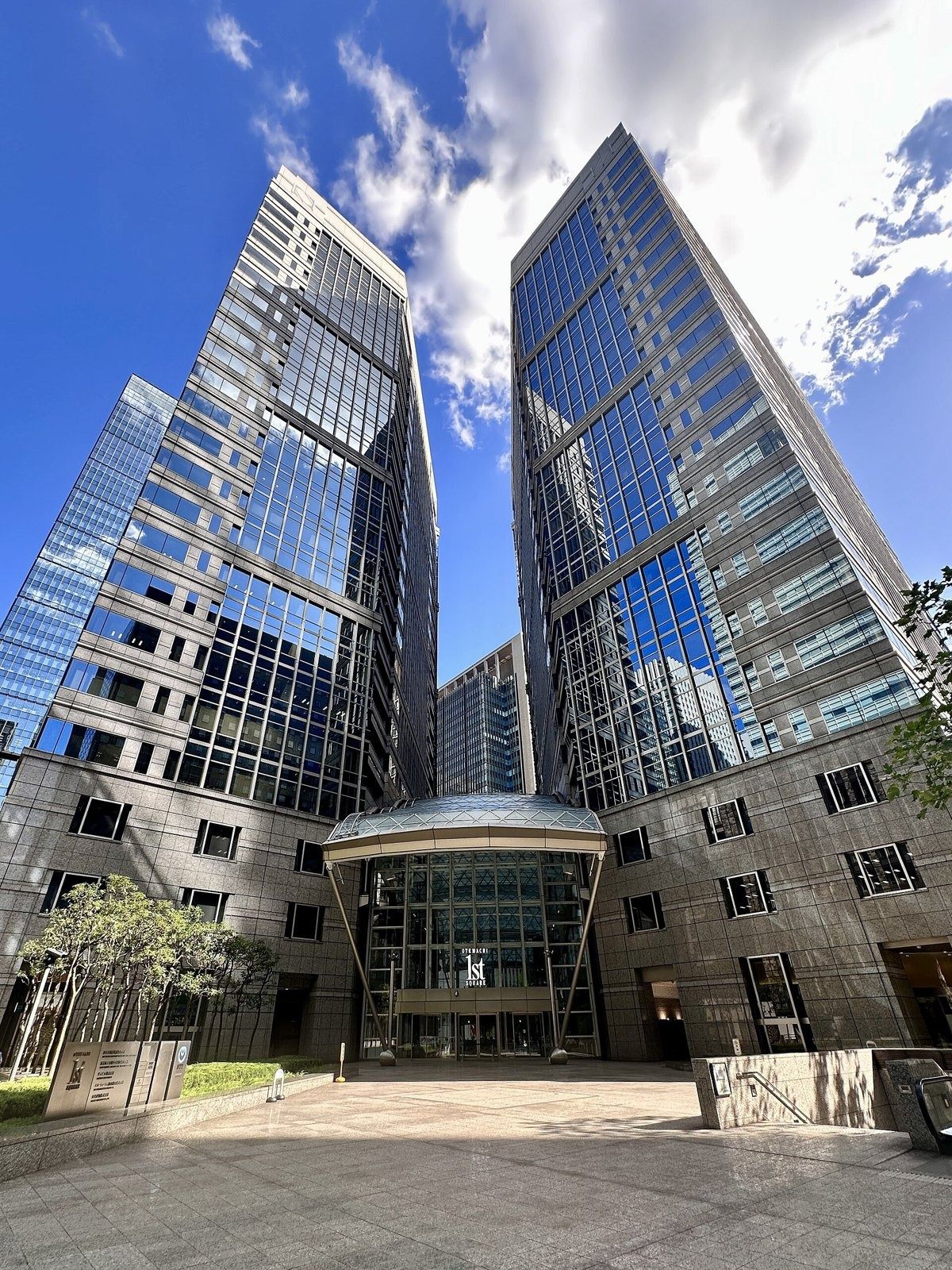 NTT: Twin glass office towers with a glass entrance between them