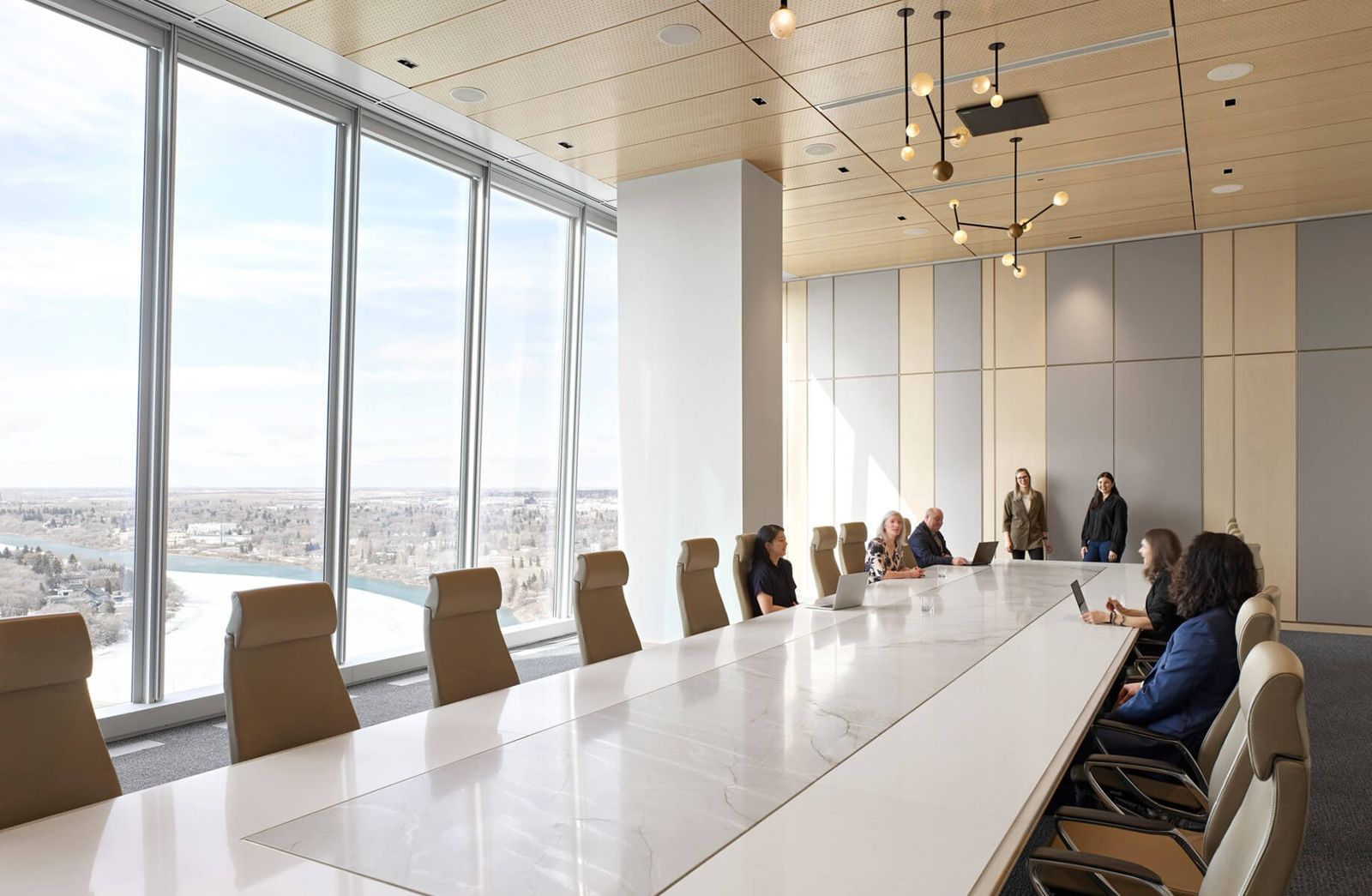 Nutrien: A long white boardroom table with people seated beside a wall of windows