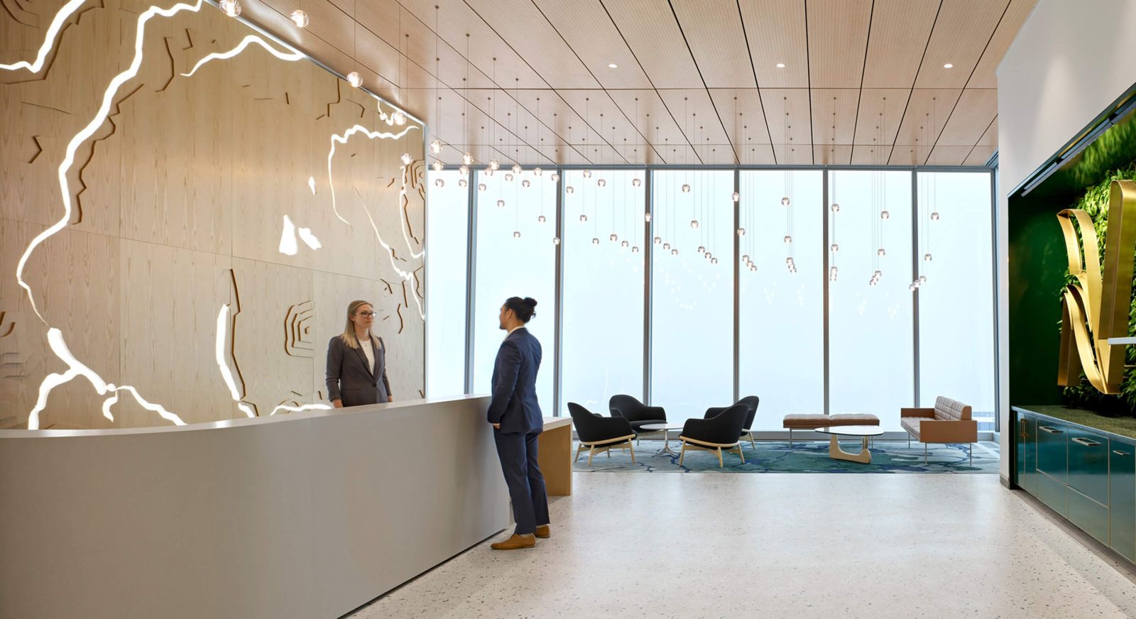Nutrien: A reception desk with a backlit relief wall and floor-to-ceiling windows