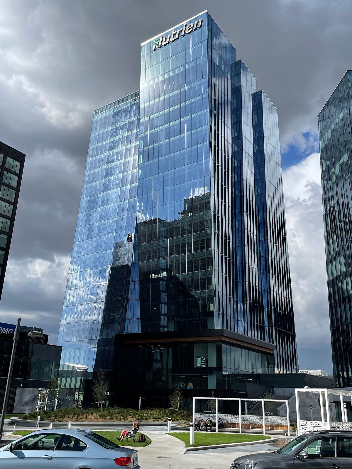 Nutrien: A tall blue glass office tower against a cloudy sky
