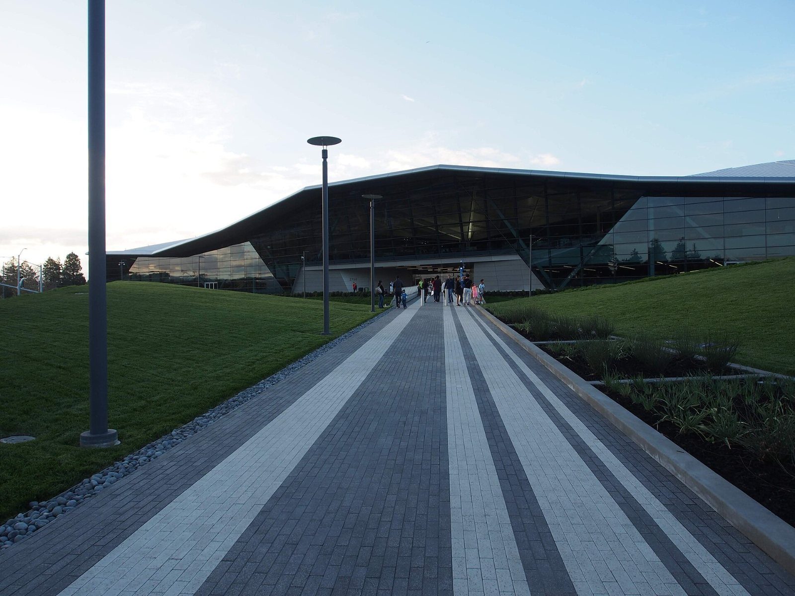 Striped paved path toward the low angled building