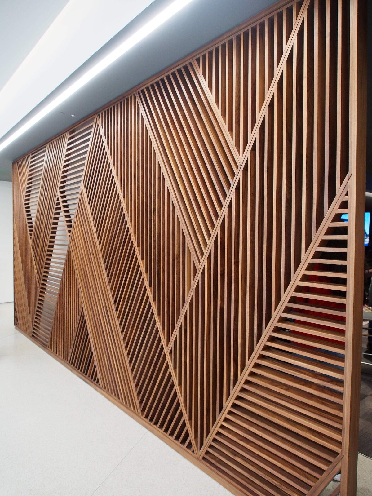 Wooden slatted screen with diagonal pattern