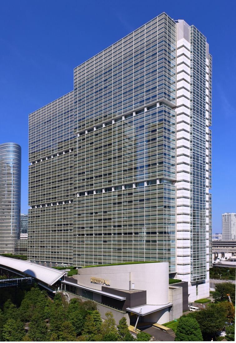 Obayashi: Tall glass office tower with a curved low building at its base