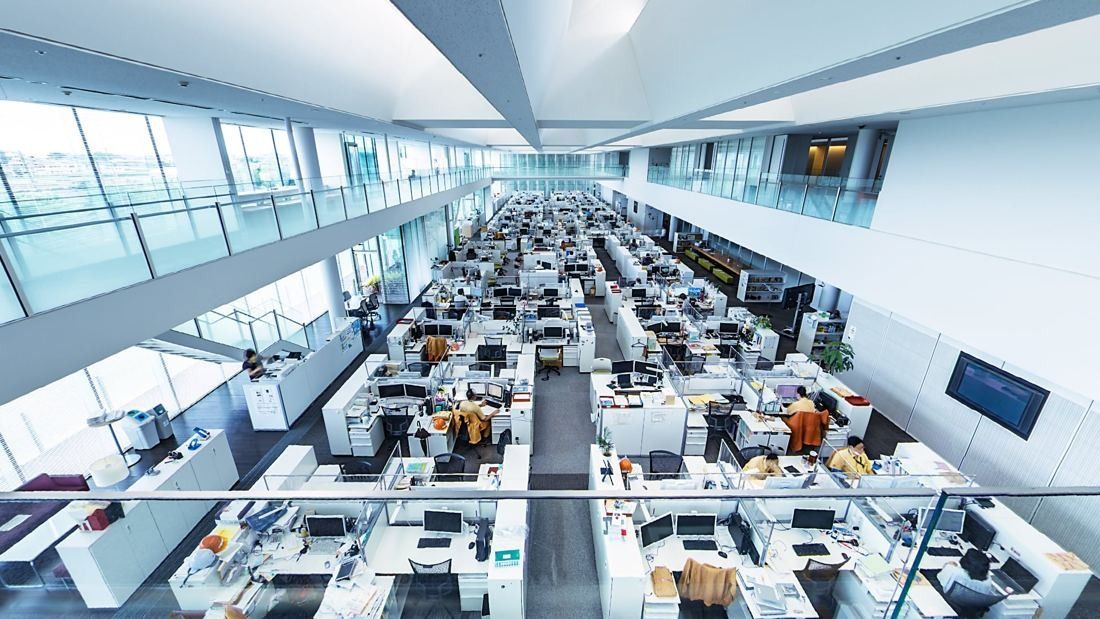 Obayashi: Wide open-plan office seen from an upper gallery, with rows of white desks