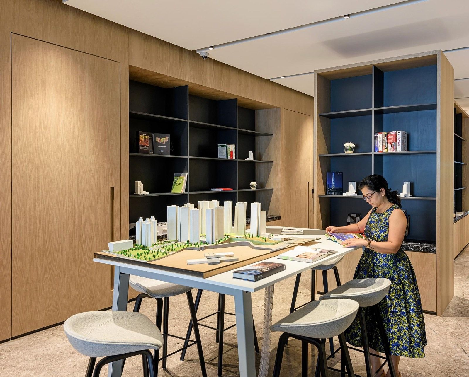Oberoi Realty: A materials table with building models and shelves of samples