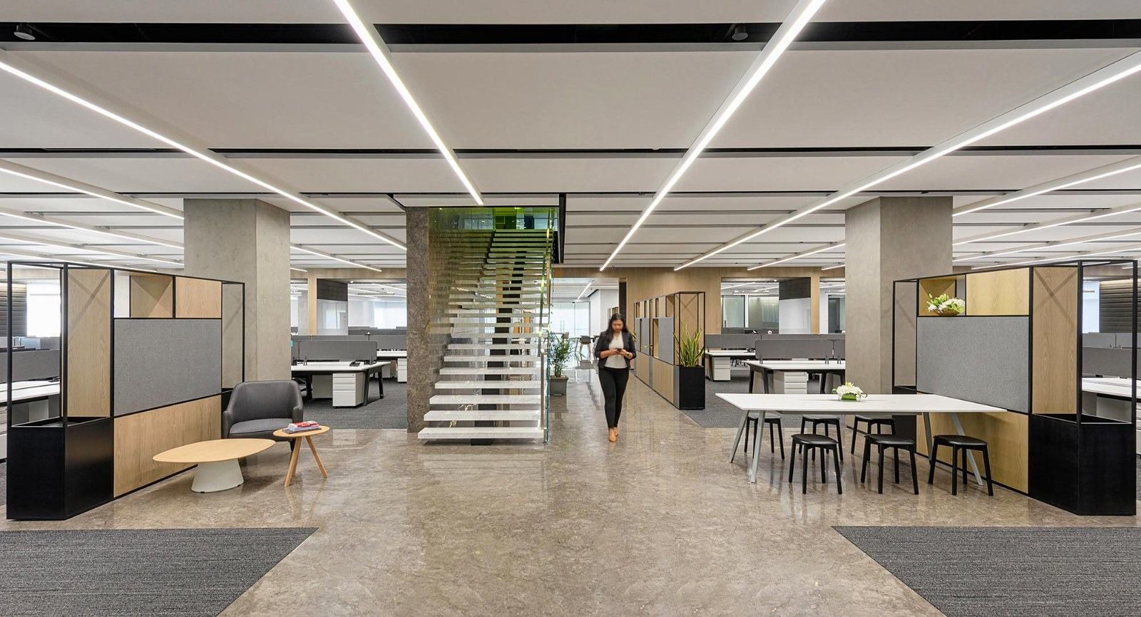 Oberoi Realty: Open desks under linear lights with a stair