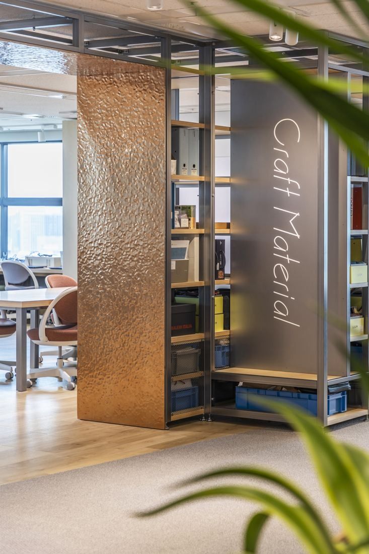 Okamura: Copper-clad column with shelves and the words Craft Material