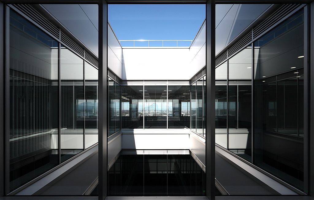 Olympus: Glass walls framing an inner courtyard between building wings