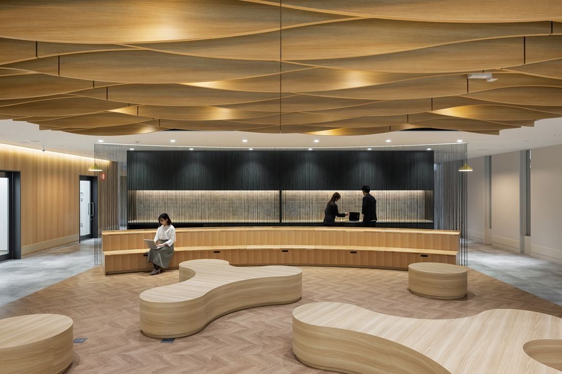 Olympus: Lounge with a wavy wooden ceiling, curved wooden benches and tiered seating