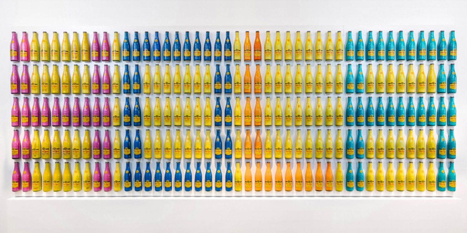 Oracle: A wall of Topo Chico bottles spelling HOLA
