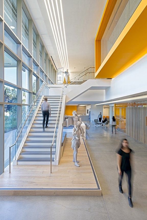 Palo Alto Networks: A bright stair with orange accents beside tall windows