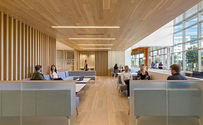 Palo Alto Networks: A long lounge with grey sofas under a timber ceiling