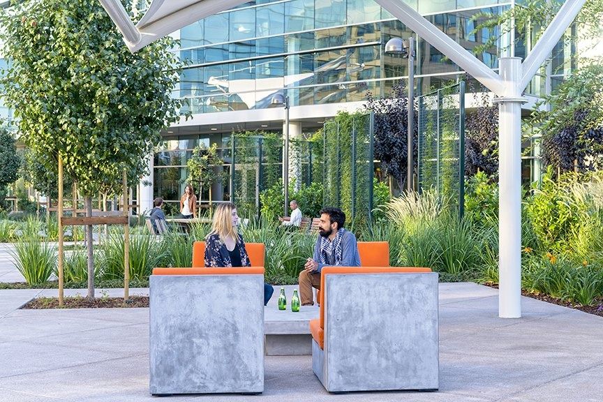 Palo Alto Networks: An outdoor courtyard with orange chairs under white shade structures