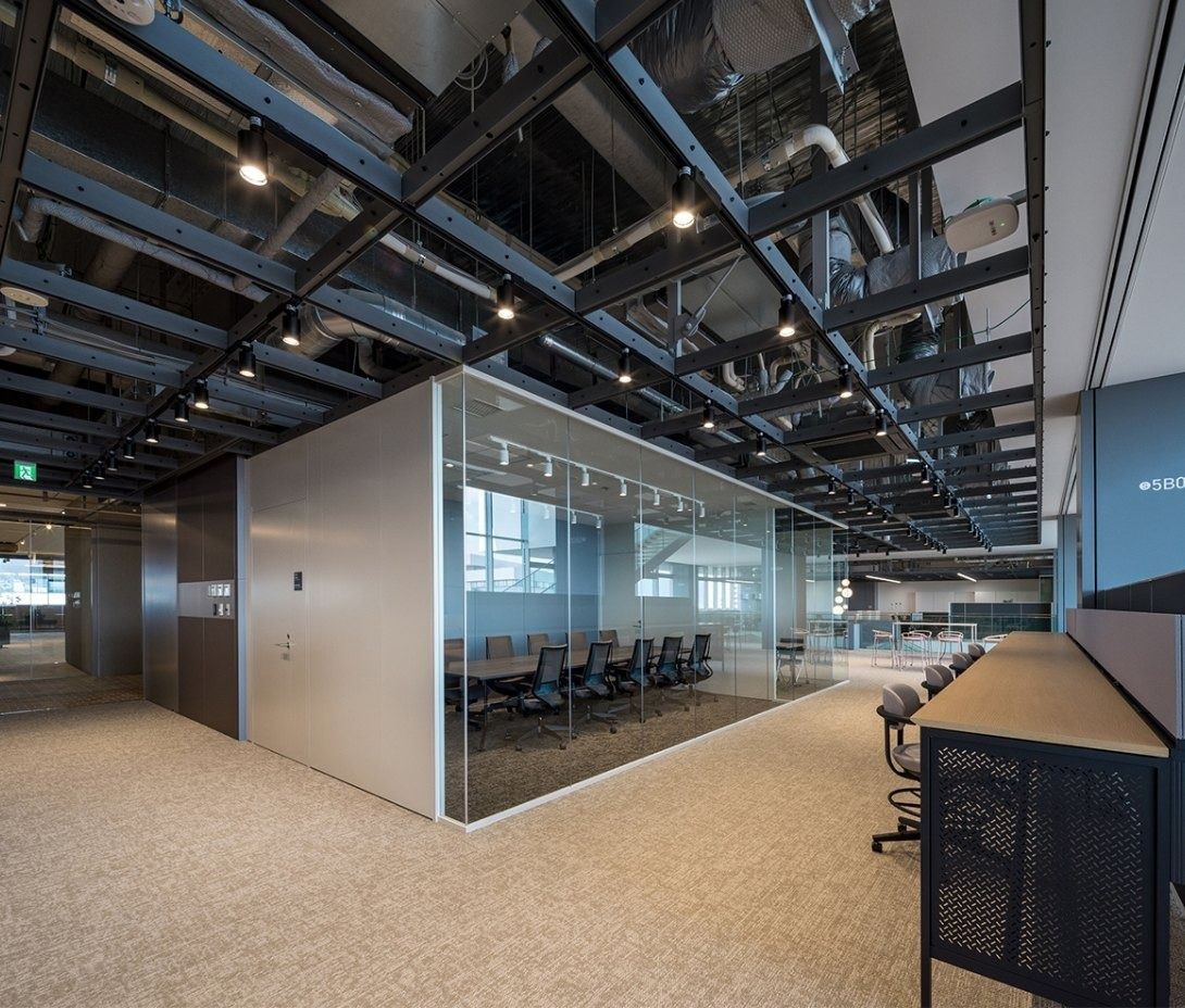 Panasonic: Steel grid ceiling over a glass-walled room and work counter