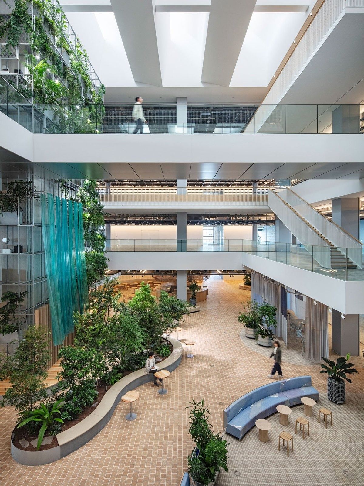 Panasonic: View down into a planted atrium with curved benches