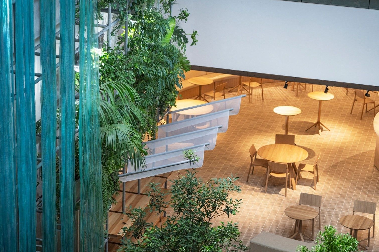 Panasonic: Wooden tables on a terrace above the atrium
