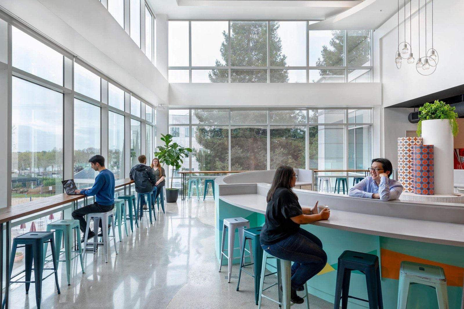 PayPal: A two-storey café counter with stools by tall windows