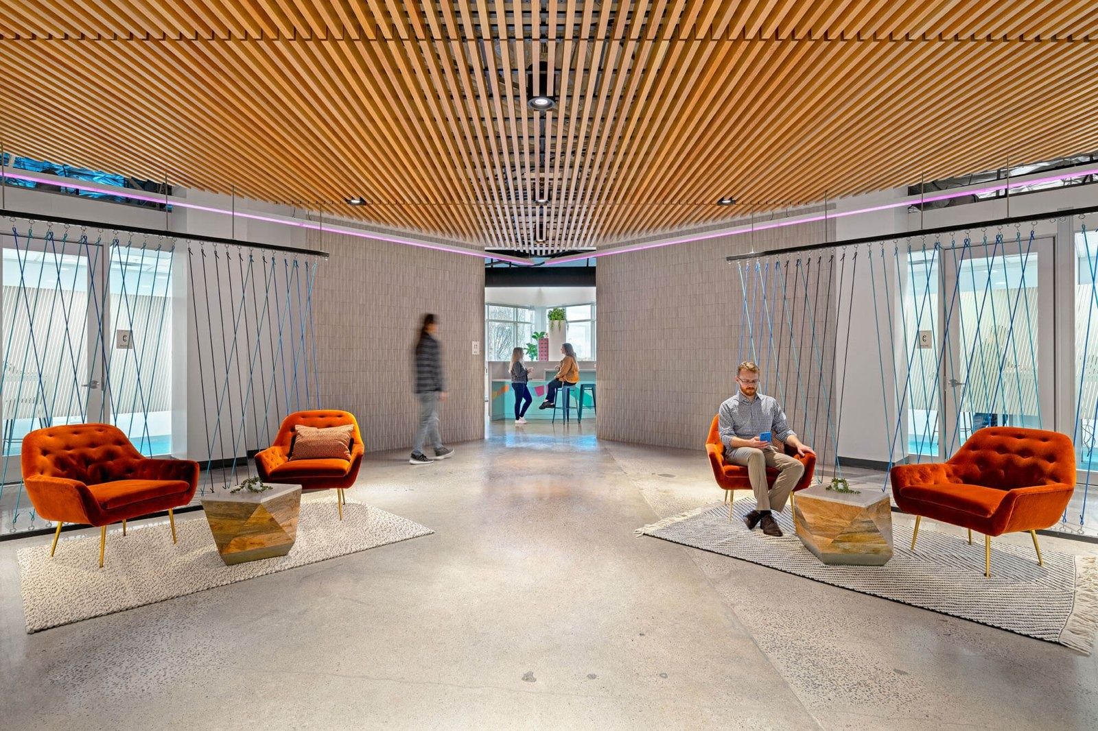 PayPal: Orange armchairs under a timber slat ceiling