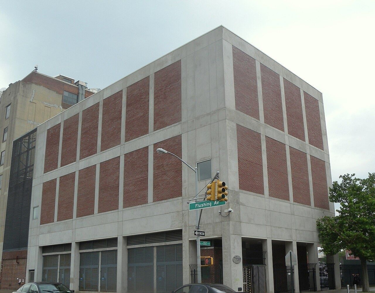 Large brick and concrete factory building on a street corner