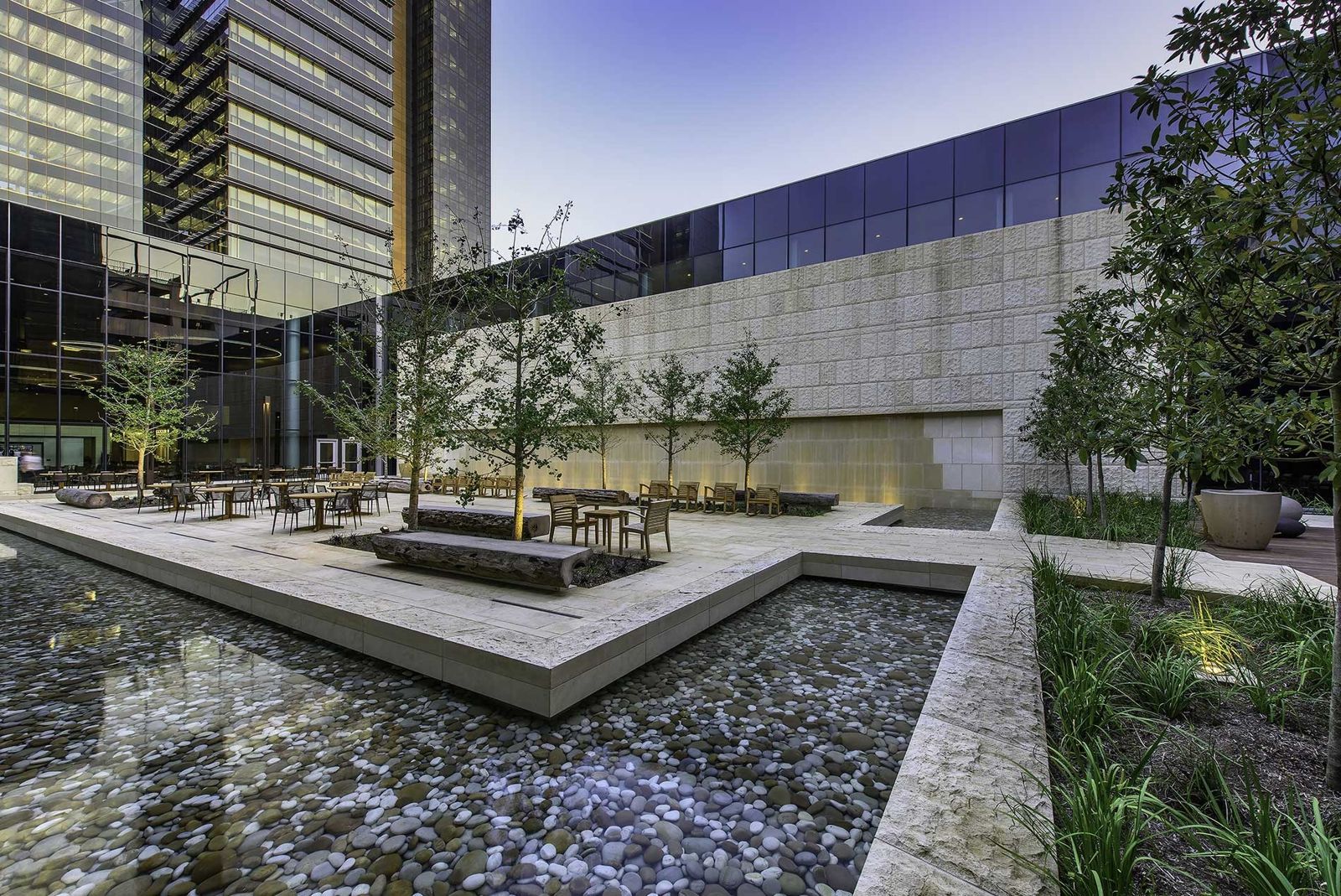 Phillips 66: A shallow pool and tables in a limestone courtyard