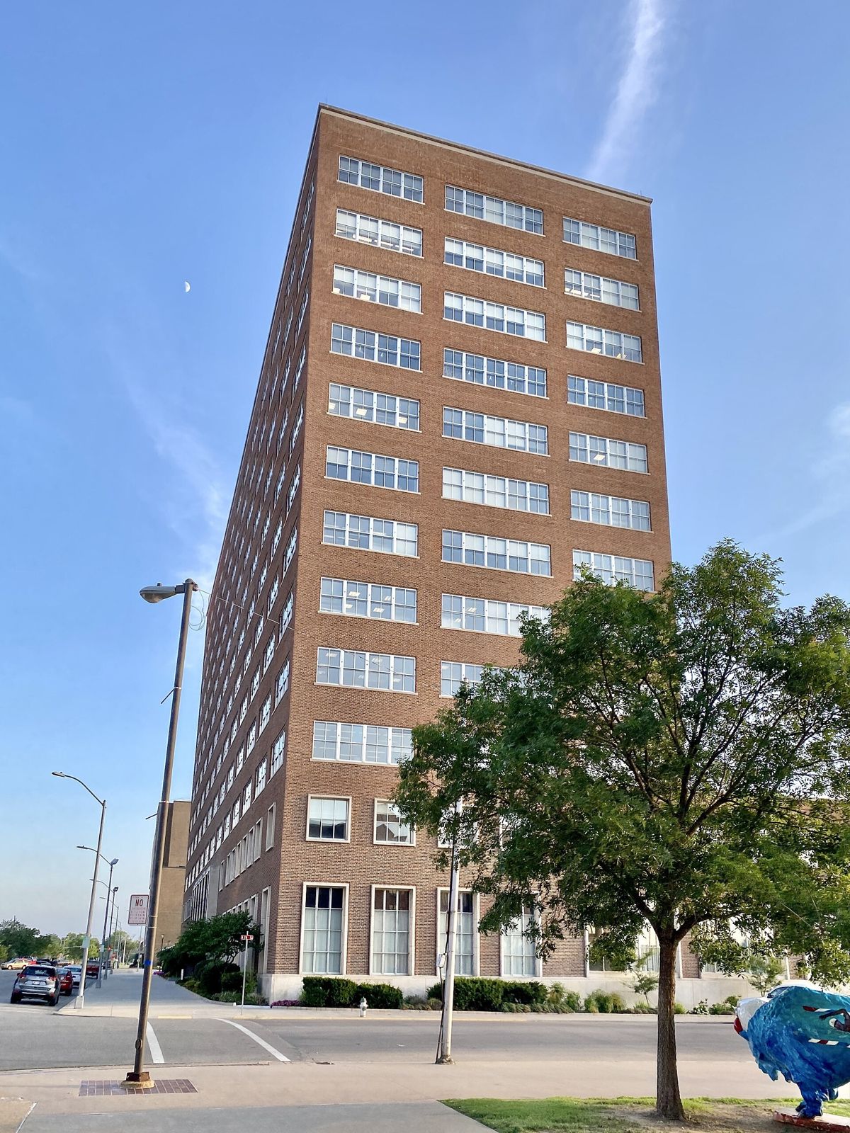 Phillips 66: Looking up at a brick office tower beside a tree