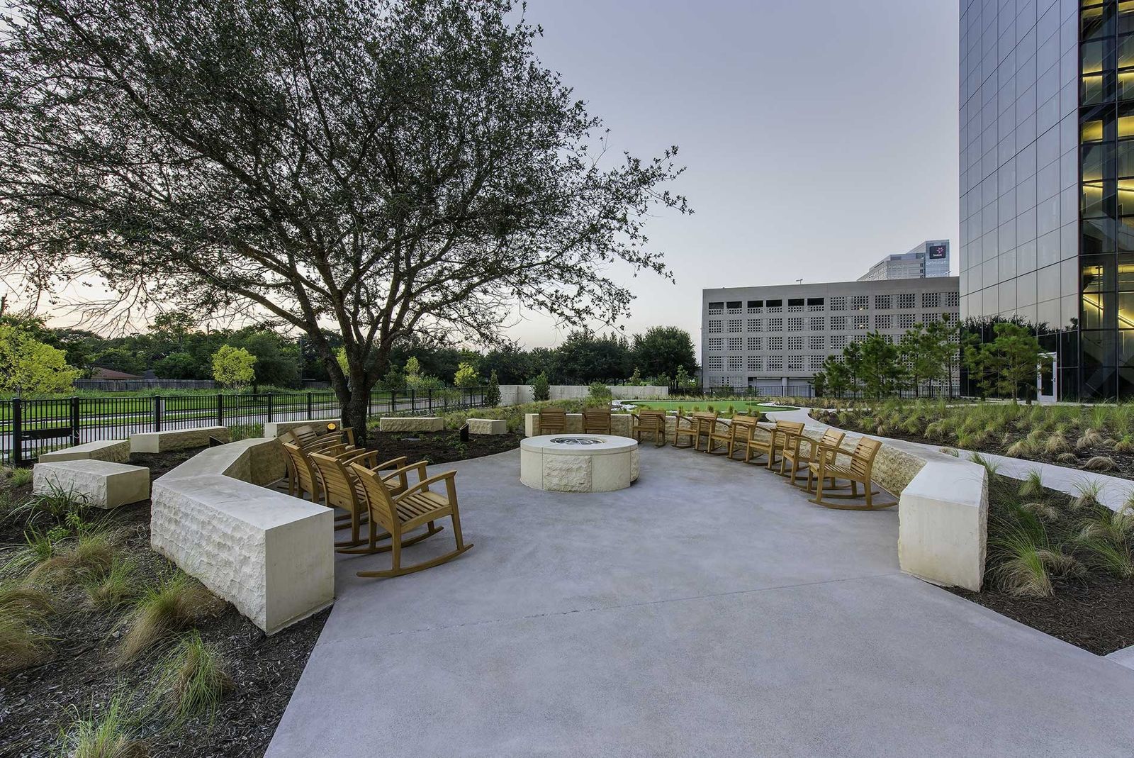 Phillips 66: Rocking chairs and stone benches under an oak tree