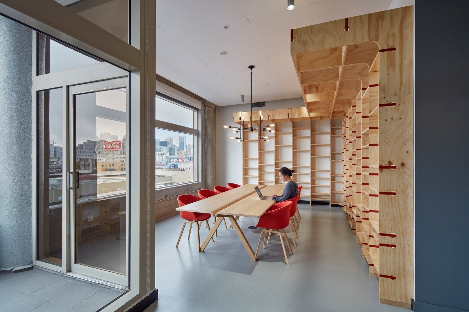 Pinterest: A long table beside a wall of wooden cubbies
