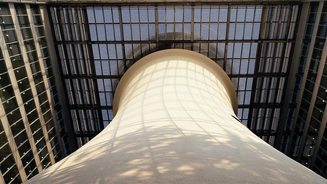 Pirelli: Looking up at the top of a white cooling tower under a glazed roof