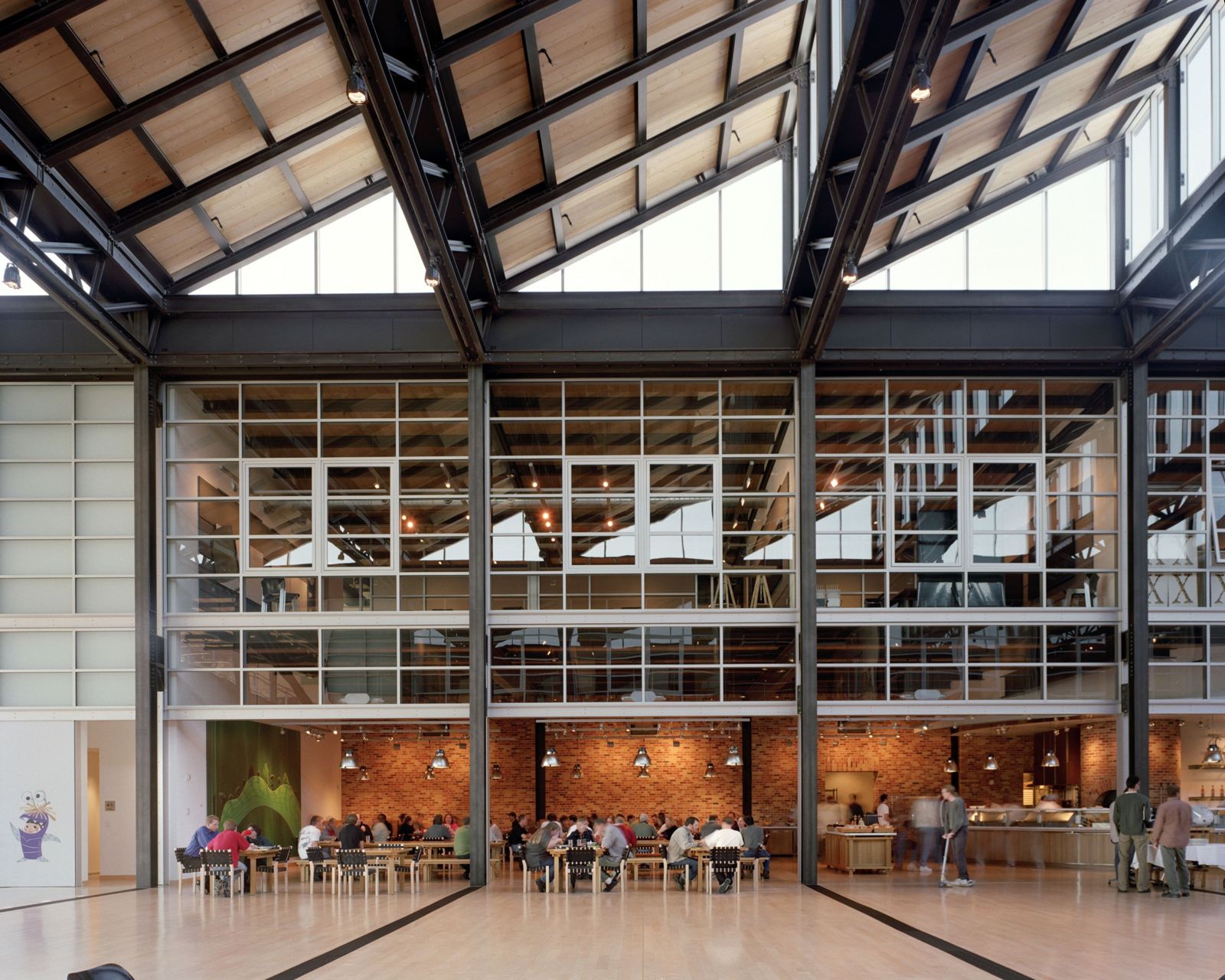Pixar Animation Studios: Atrium café below brick walls and steel trusses