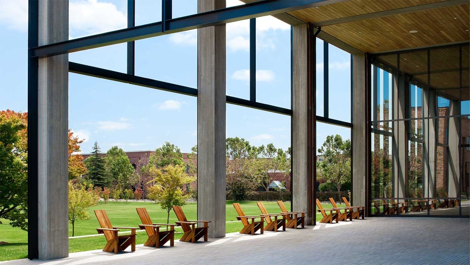 Pixar Animation Studios: Glass porch with wooden chairs facing a lawn