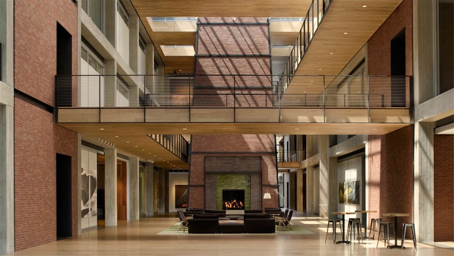 Pixar Animation Studios: Tall interior hall with a brick fireplace and a bridge