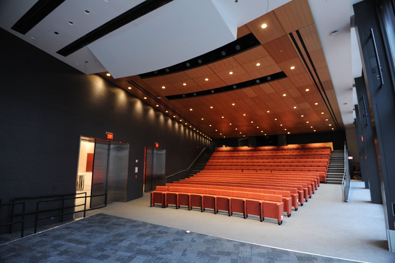 PNC Financial Services: Auditorium with rows of orange seats under a wooden ceiling