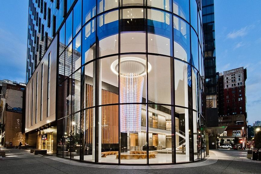 PNC Financial Services: Curved glass corner lobby lit at night