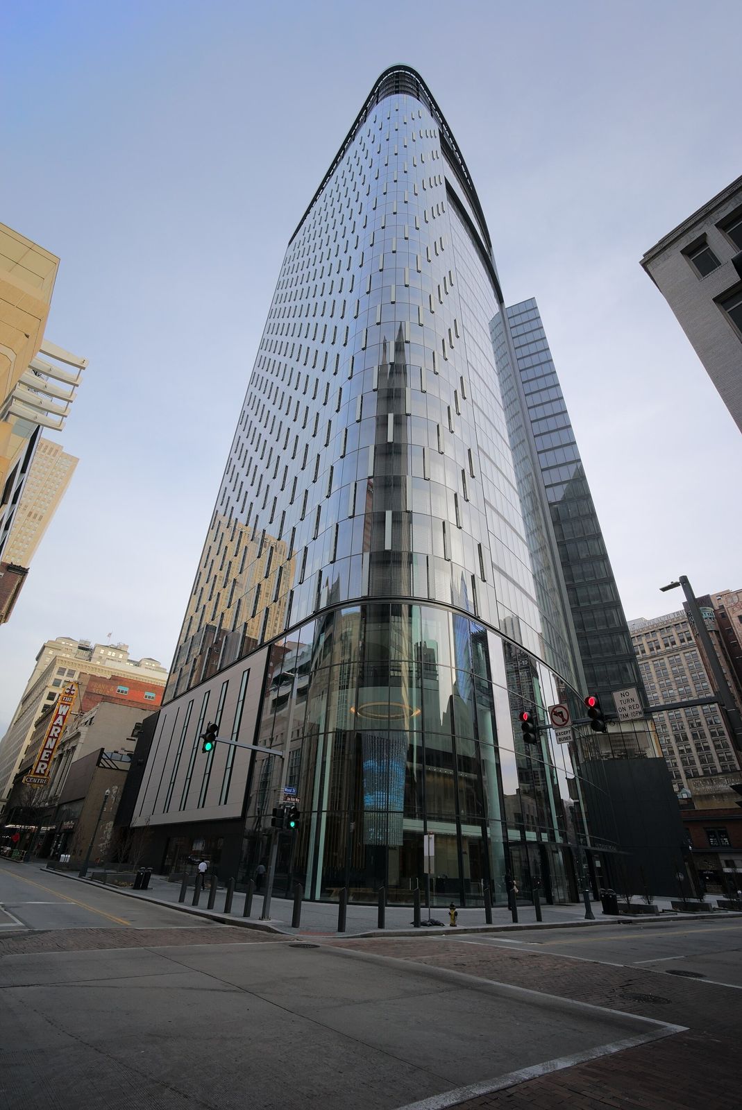 Curved glass tower at a downtown street corner