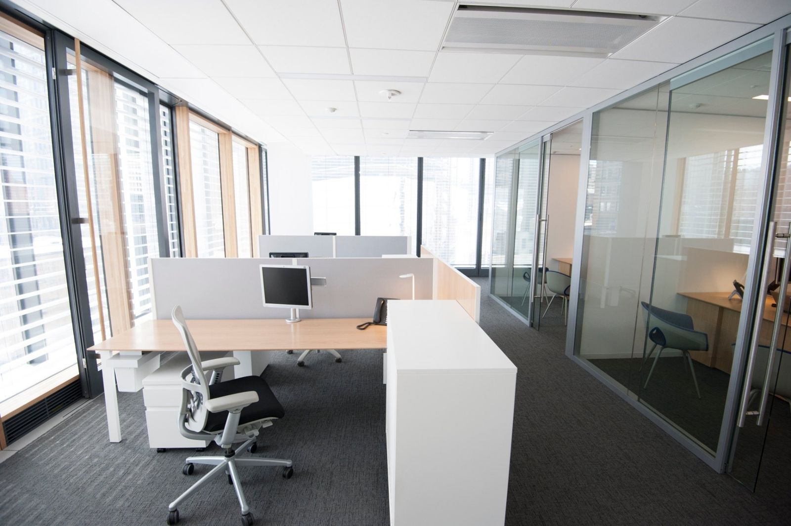 PNC Financial Services: Desks by tall windows next to glass-walled offices