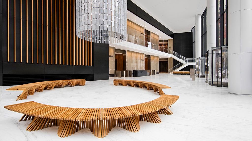 PNC Financial Services: Lobby with a long curved wooden bench under a hanging light sculpture