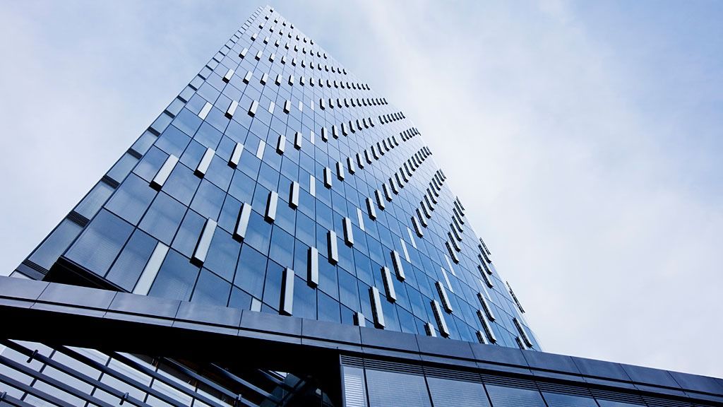 PNC Financial Services: Looking up a glass facade dotted with open window panels