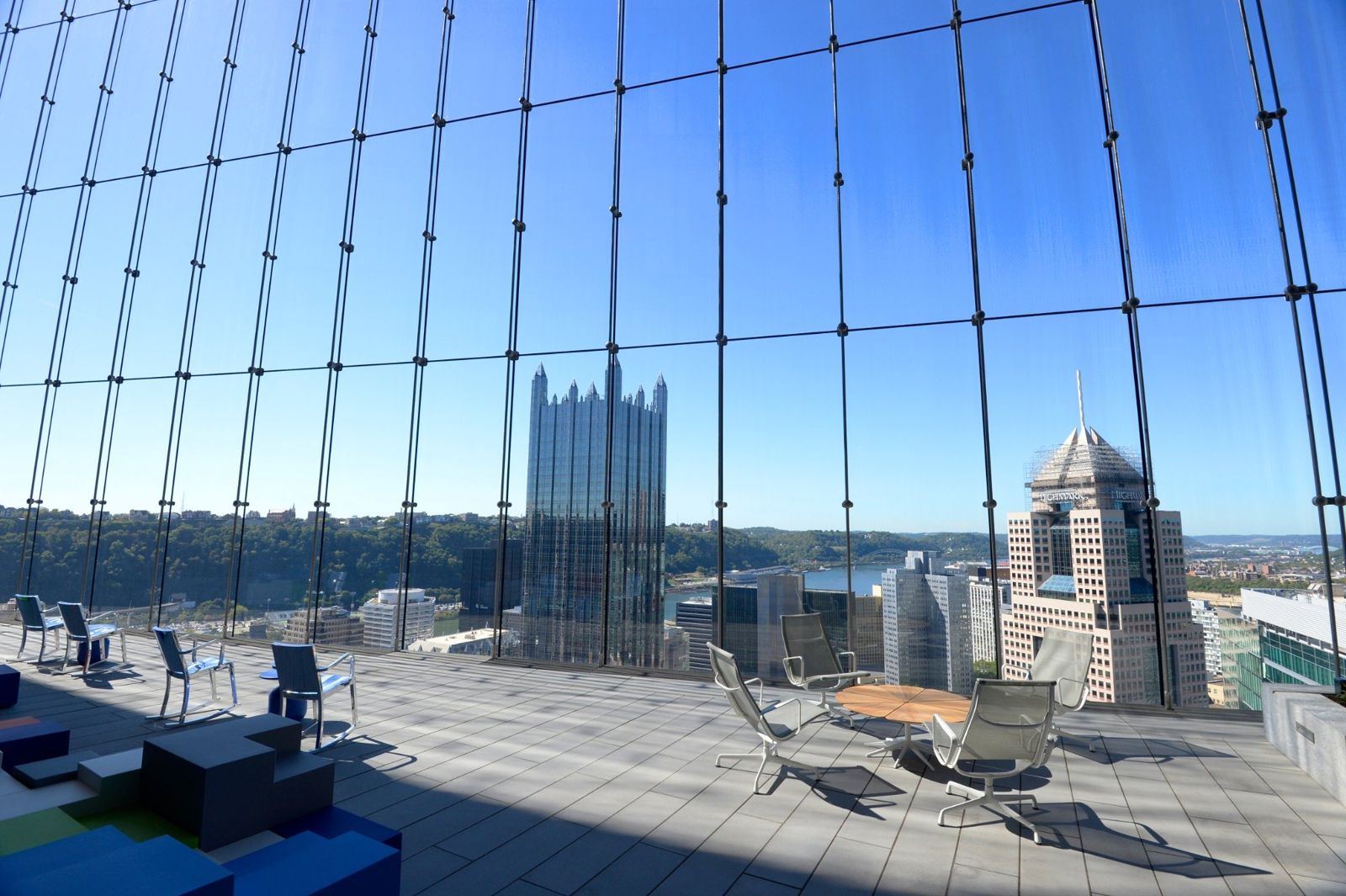 PNC Financial Services: Lounge chairs facing a glass wall with a view of downtown towers